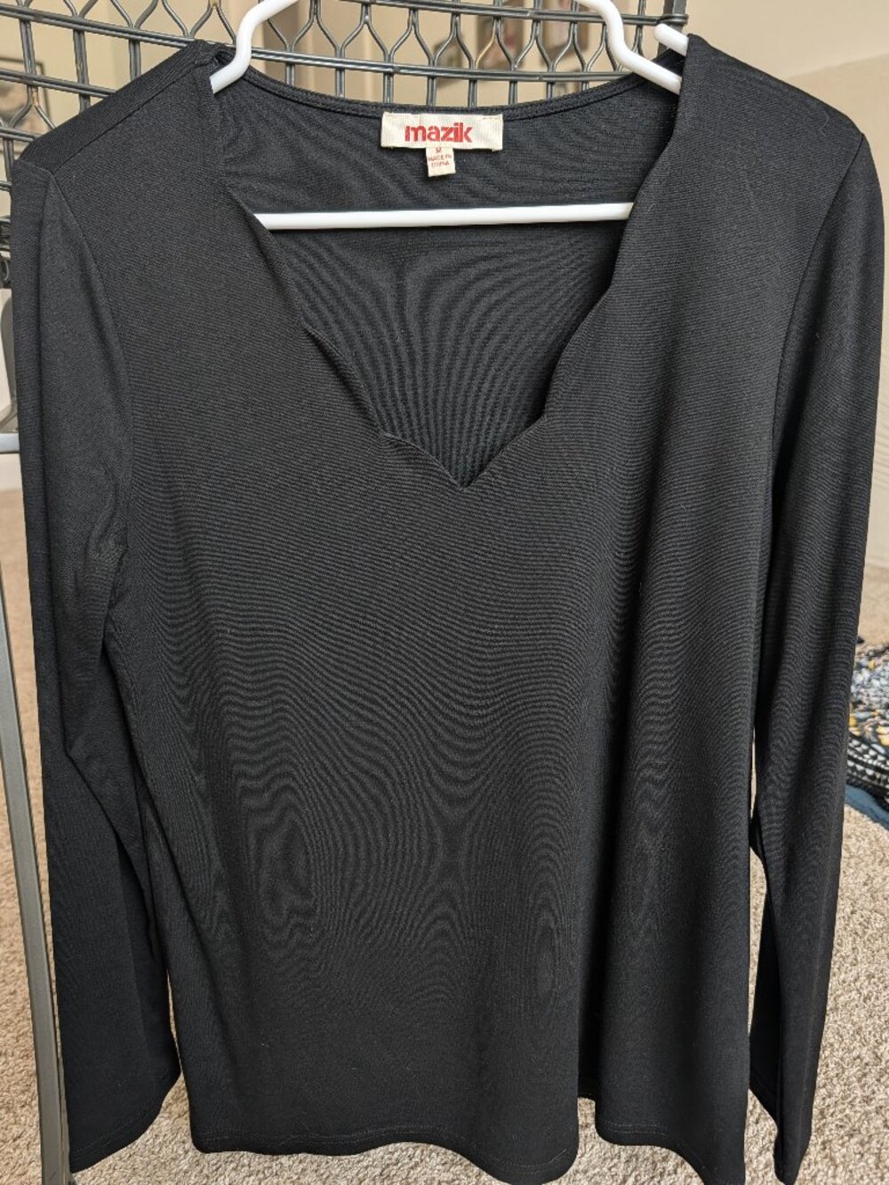 Black long sleeve top with scalloped neckline